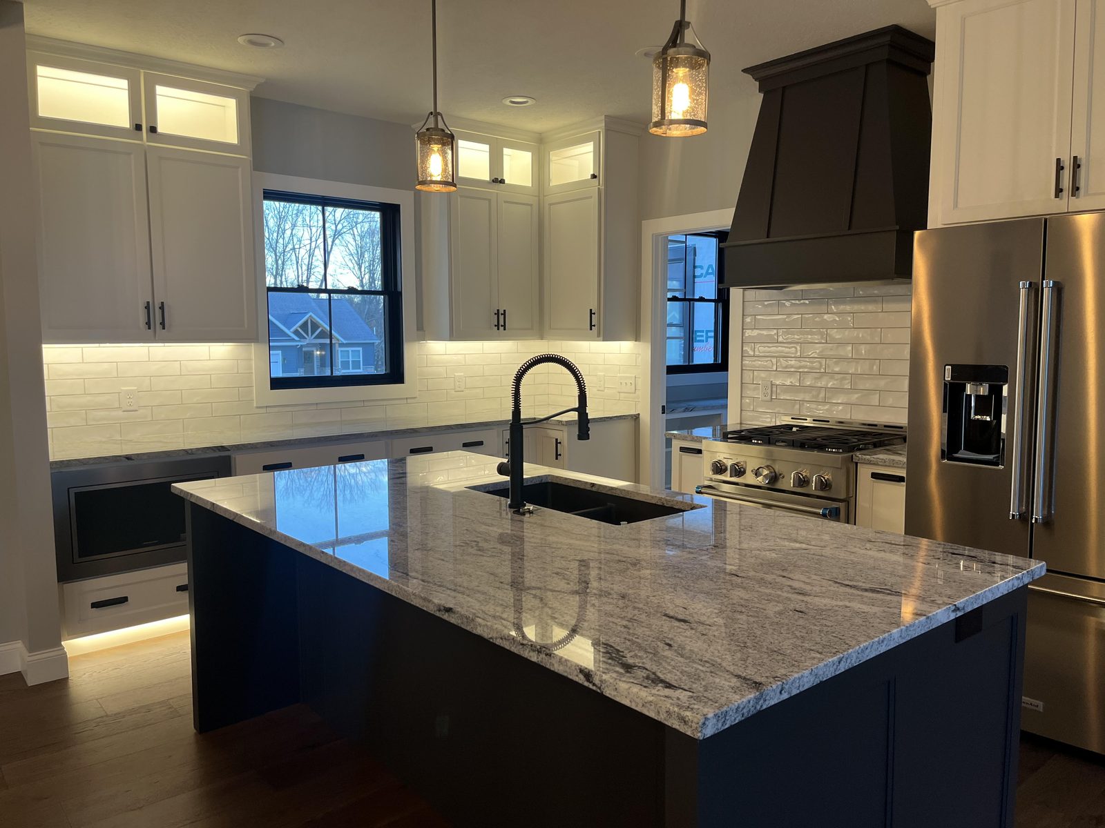 Custom kitchen with navy island and marble countertops